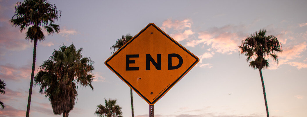 The image shows a yellow, diamond-shaped traffic sign with the large black lettering 
