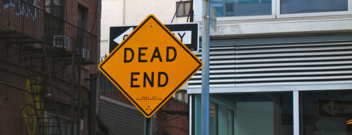 The image shows a yellow diamond-shaped traffic sign with the black inscription 